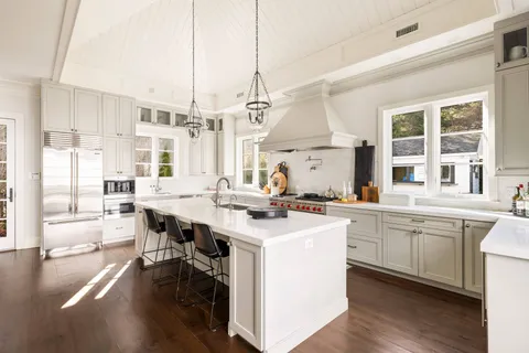 a kitchen with stainless steel appliances kitchen island granite countertop a sink and cabinets