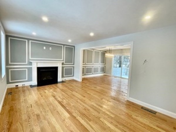 39 Staples Street Billerica, MA 01821 - Photo 13 of 25 a view of empty room with a fireplace and wooden floor