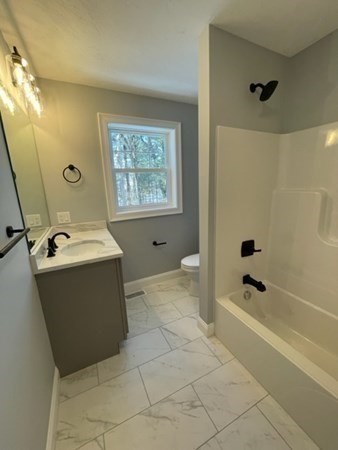39 Staples Street Billerica, MA 01821 - Photo 16 of 25 a bathroom with a bathtub sink and mirror