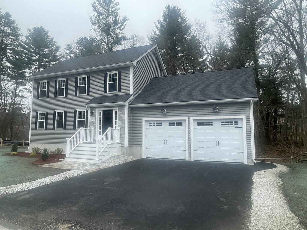 39 Staples Street Billerica, MA 01821 - Photo 2 of 25 a front view of a house with a yard and garage