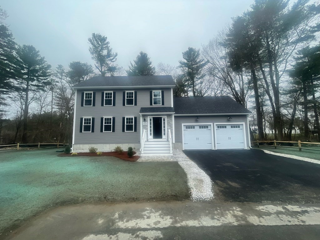 39 Staples Street Billerica, MA 01821 - Photo 3 of 25 a view of a yard in front of a house with large trees