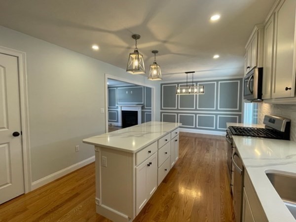 39 Staples Street Billerica, MA 01821 - Photo 7 of 25 a kitchen with stainless steel appliances granite countertop a sink stove and refrigerator