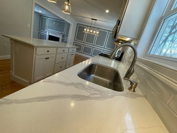 39 Staples Street Billerica, MA 01821 - Photo 8 of 25 a kitchen with a sink and a refrigerator