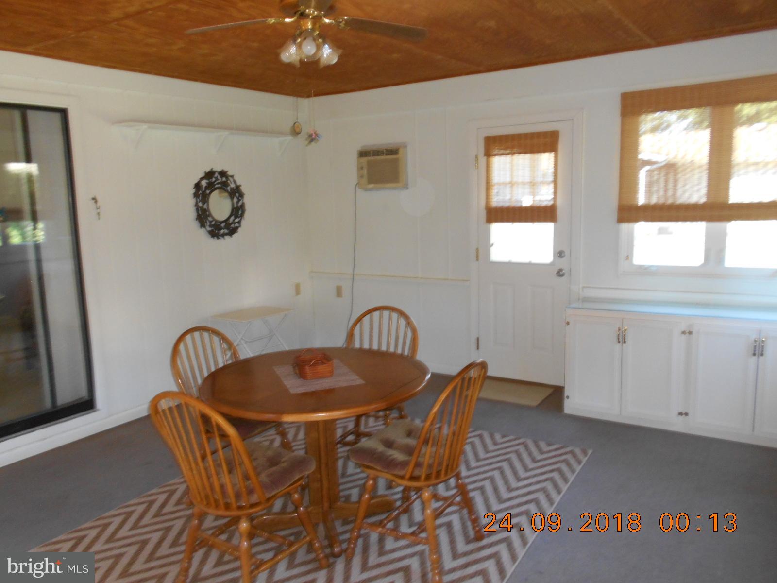 506 Harbor Road Ocean View, DE 19970 - Photo 6 of 30 Enclosed porch with heat & air, door to outside.