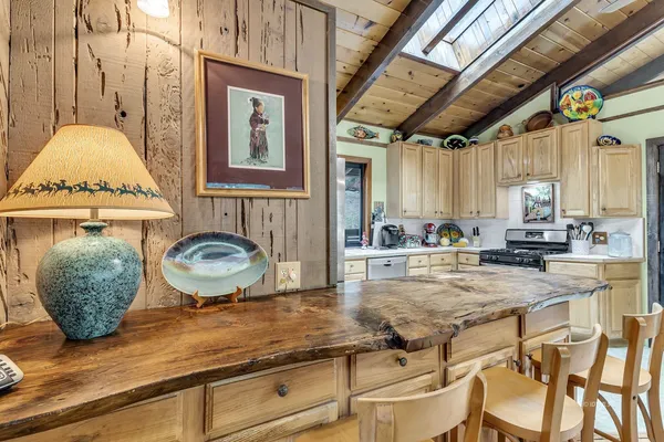 a view of a patio with dining table and chairs with wooden floor and fence