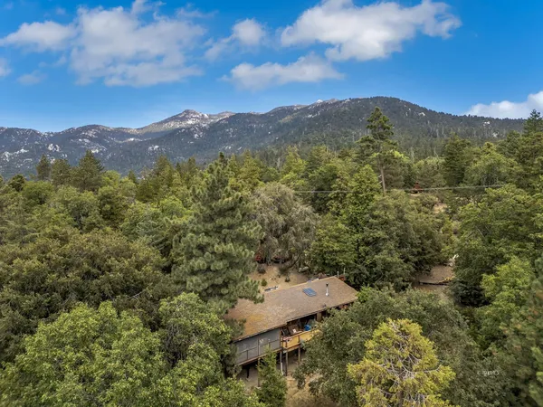an aerial view of a house with roof deck and outdoor seating