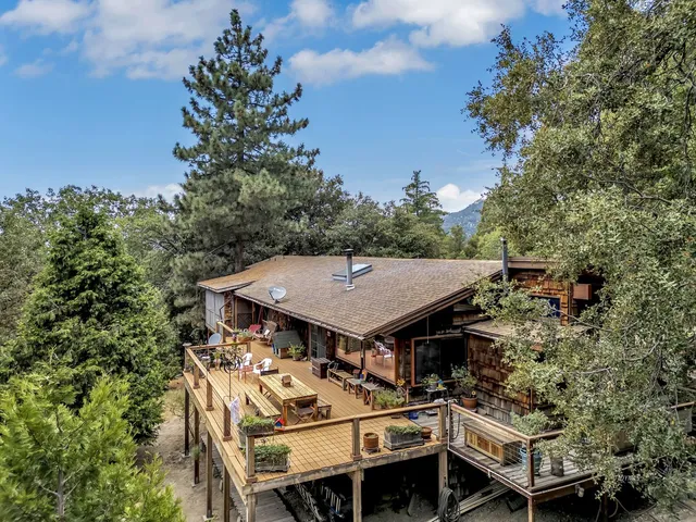 a view of a balcony with wooden floor and outdoor seating