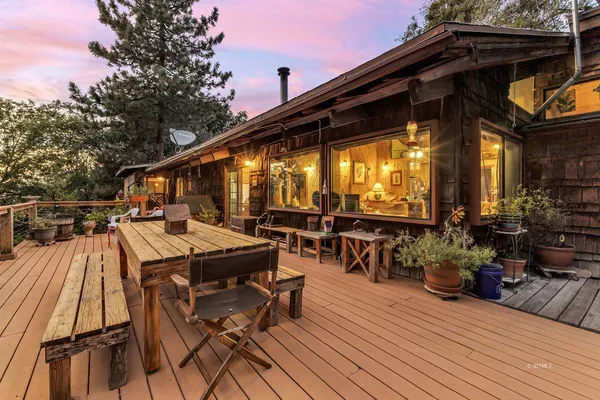 an aerial view of house with outdoor space and seating
