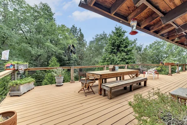 a view of a porch with wooden floor and a stairs
