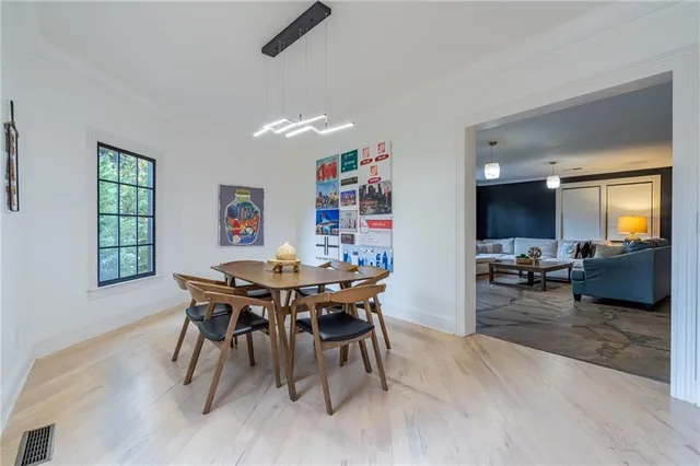 a bed room with a bed and painting on the wall