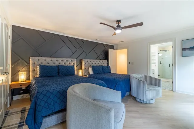 a front view of a building with lots of trees and plants