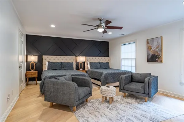 a bedroom with a large bed and a chandelier