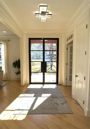 a living room with furniture a chandelier and a window
