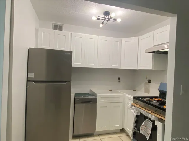 a kitchen with a stove and a refrigerator