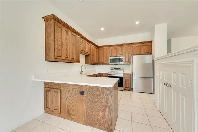 a kitchen with a sink window and cabinets