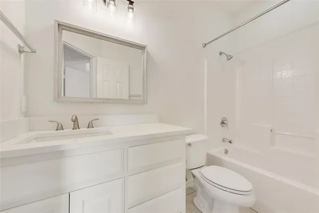 an empty room with chandelier fan