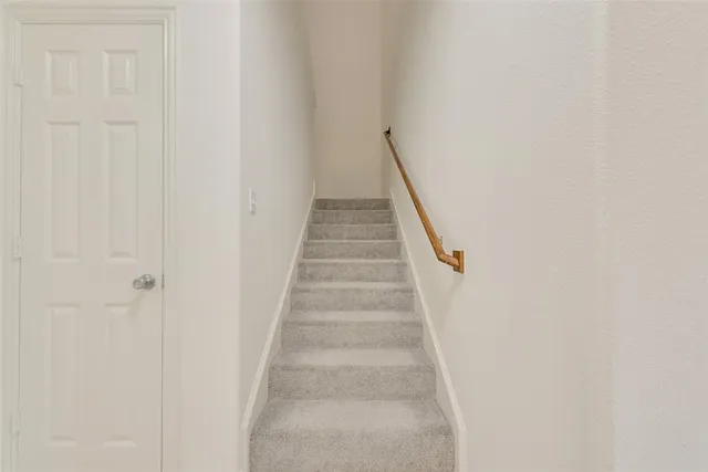 a view of staircase with white walls
