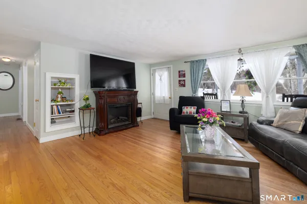 a living room with furniture a flat screen tv and a fireplace