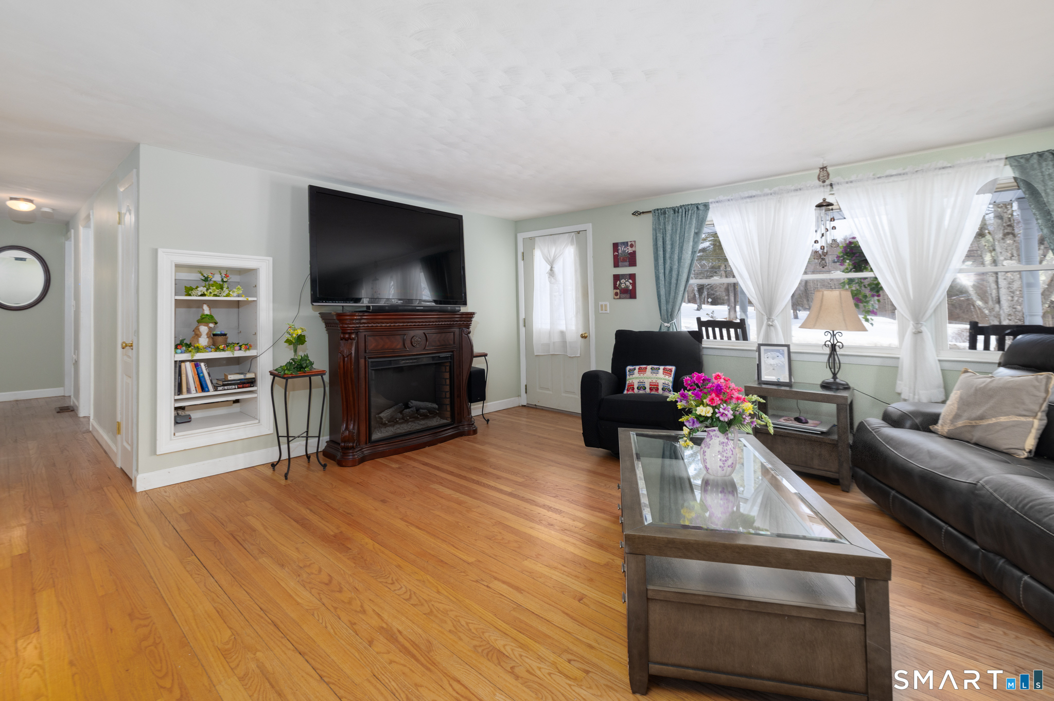 351 Platt Hill Road Winchester, CT 06098 - Photo 12 of 40 a living room with furniture a flat screen tv and a fireplace