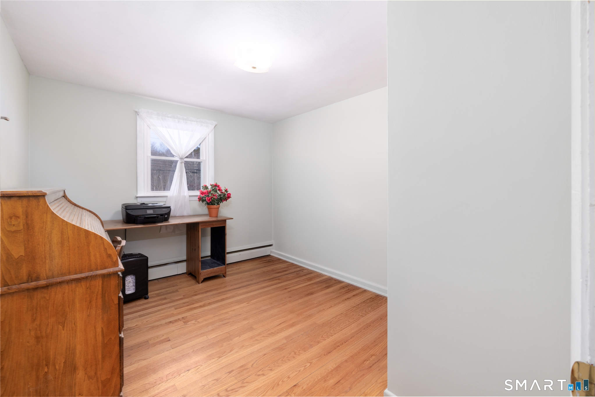 351 Platt Hill Road Winchester, CT 06098 - Photo 15 of 40 a room with a table and a refrigerator