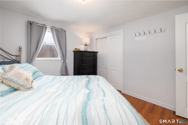 a bedroom with a bed and window