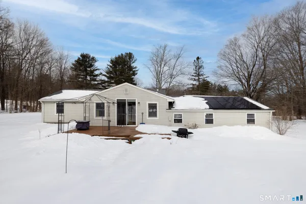 a front view of a house with yard covered in snow