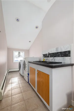 a kitchen with stainless steel appliances granite countertop a sink and a stove