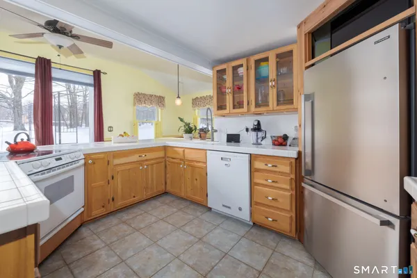 a kitchen with cabinets stainless steel appliances and a window