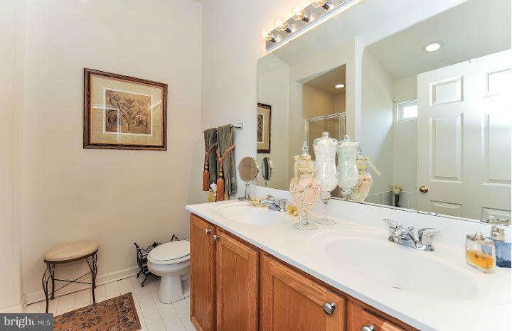 2428 Knapps Way Odenton, MD 21113 - Photo 18 of 30 a bathroom with a sink mirror vanity and toilet