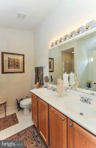 2428 Knapps Way Odenton, MD 21113 - Photo 19 of 30 a bathroom with a sink double vanity and a toilet