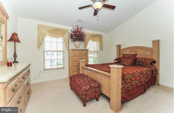 2428 Knapps Way Odenton, MD 21113 - Photo 21 of 30 a bedroom with a bed and a chandelier