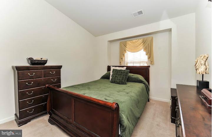 2428 Knapps Way Odenton, MD 21113 - Photo 22 of 30 a bed sitting in a bedroom next to a window with chair