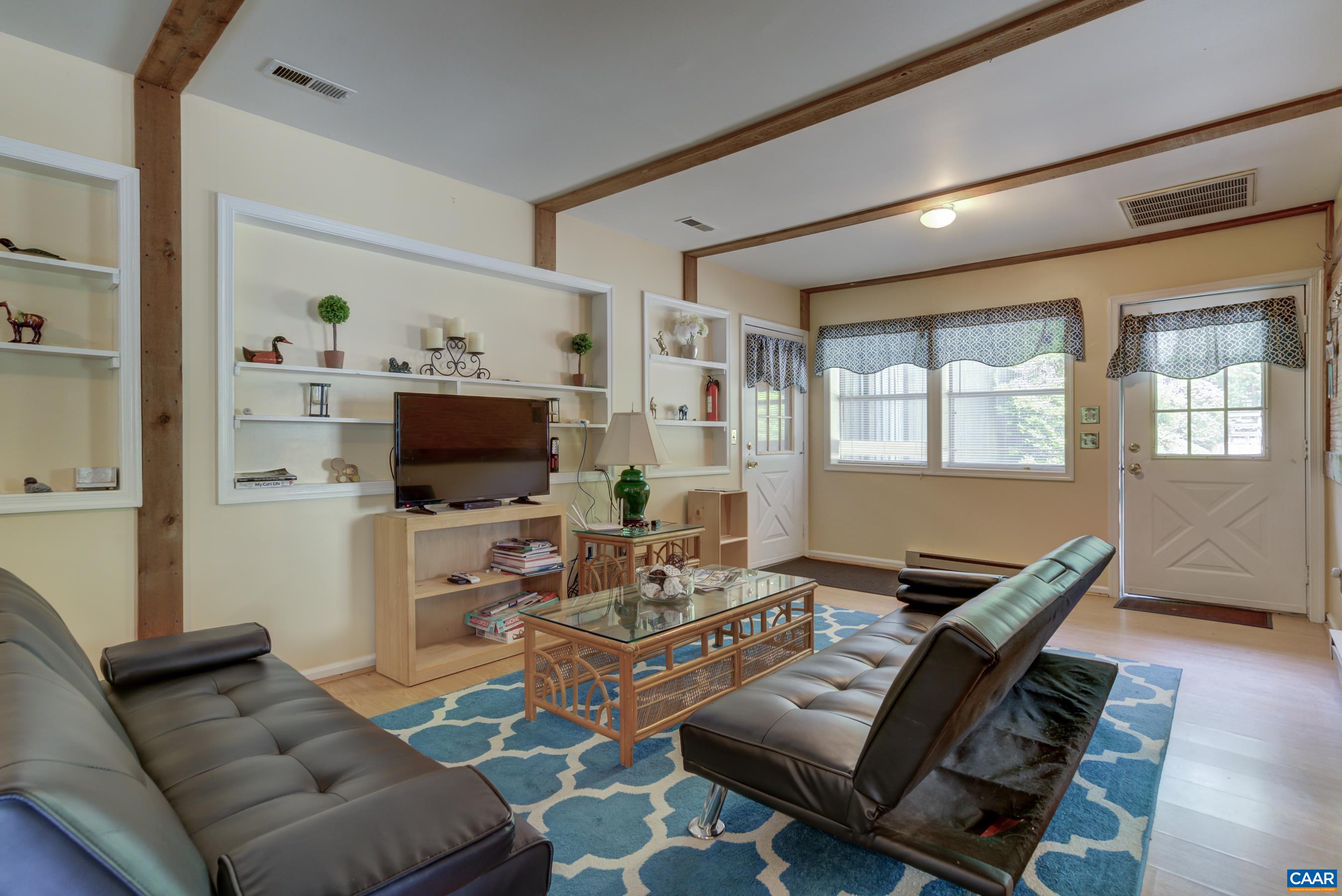 5317 Stony Point Road Barboursville, VA 22923 - Photo 52 of 69 a living room with furniture a flat screen tv and floor to ceiling window