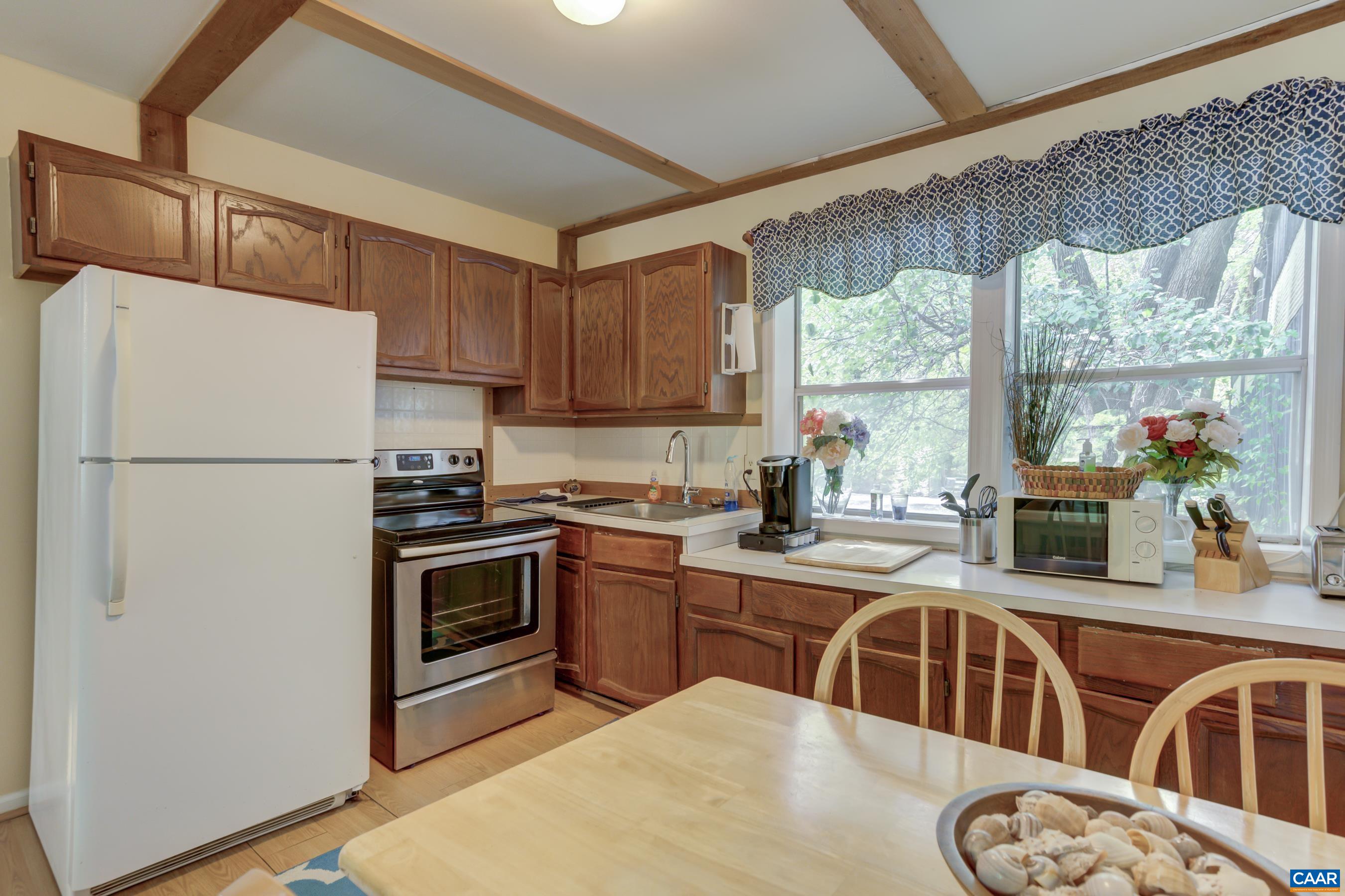 5317 Stony Point Road Barboursville, VA 22923 - Photo 54 of 69 a kitchen with stainless steel appliances granite countertop a refrigerator a stove a sink dishwasher and white cabinets with wooden floor