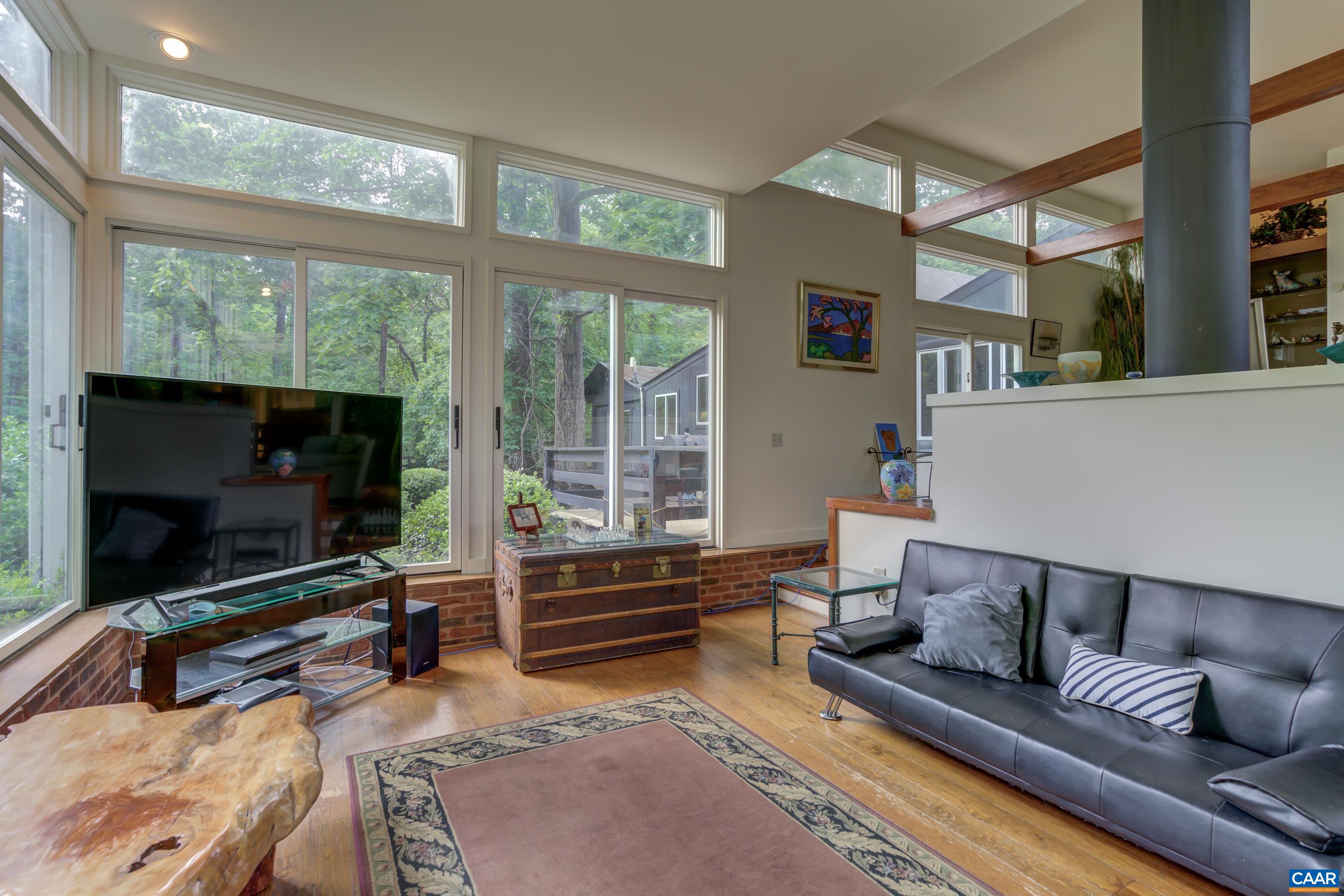 5317 Stony Point Road Barboursville, VA 22923 - Photo 8 of 69 a living room with furniture a flat screen tv and floor to ceiling window