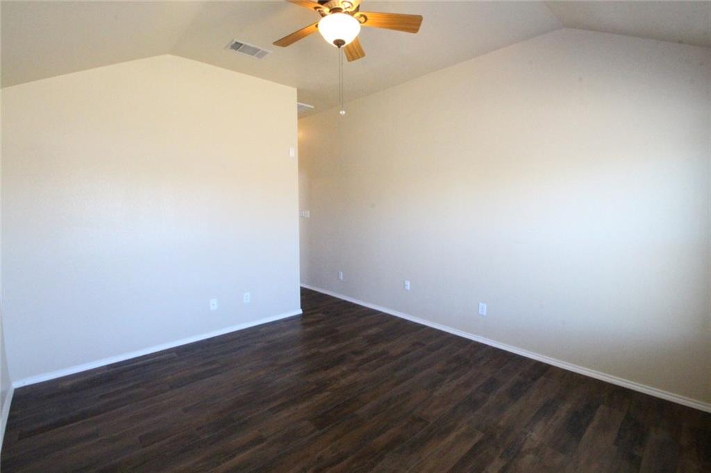 107 Inman Drive Hutto, TX 78634 - Photo 13 of 19 Spacious interior featuring vaulted ceilings and wood-finish flooring