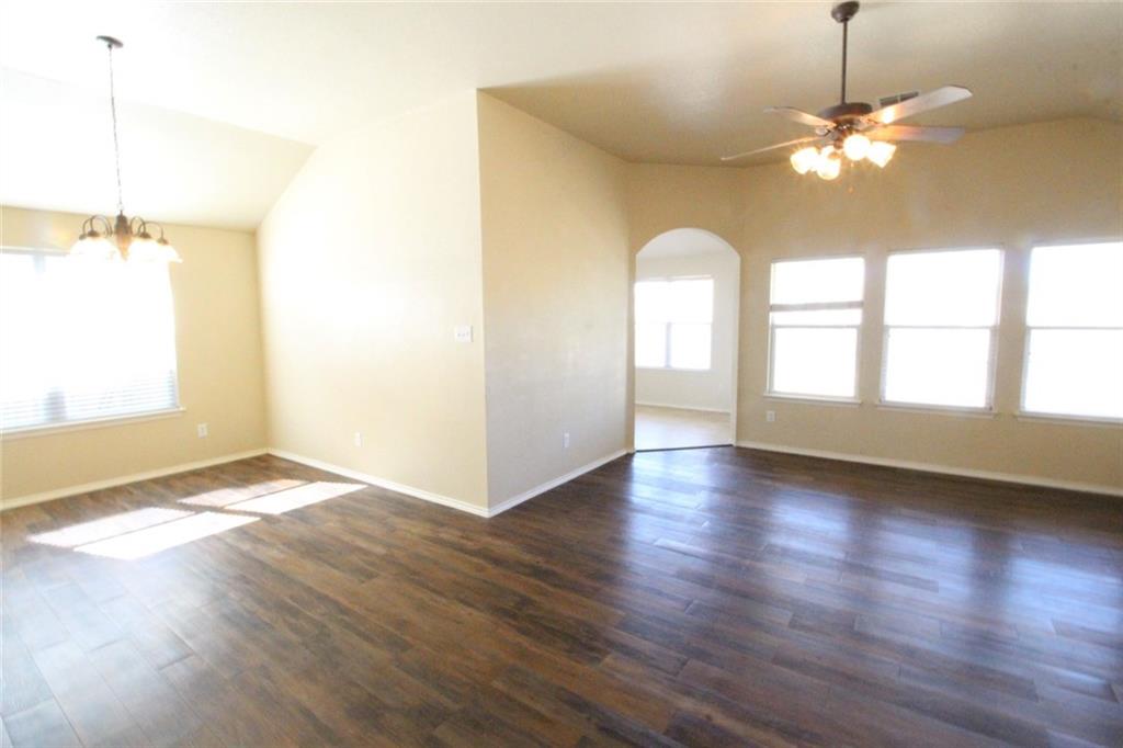 107 Inman Drive Hutto, TX 78634 - Photo 15 of 19 Spacious interior featuring wood-finish flooring, vaulted ceilings, and extensive natural light