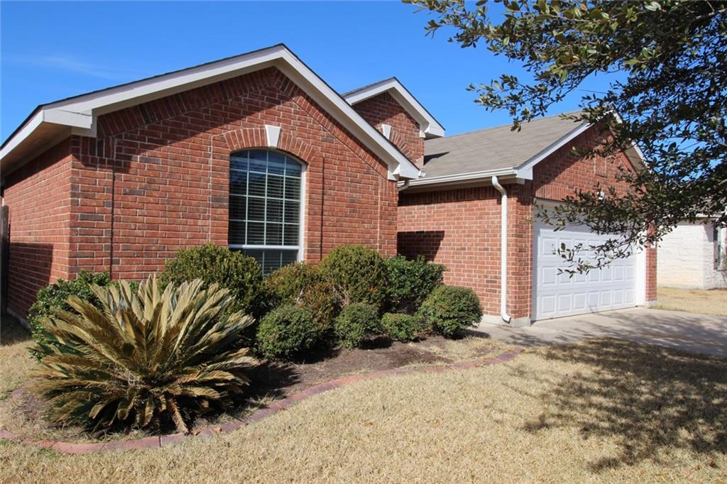 107 Inman Drive Hutto, TX 78634 - Photo 19 of 19 Brick exterior with an arched window and white trim