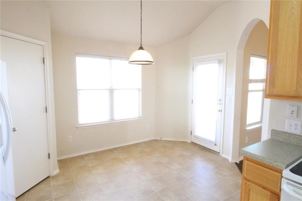 107 Inman Drive Hutto, TX 78634 - Photo 4 of 19 Dining area featuring a vaulted ceiling and tile flooring