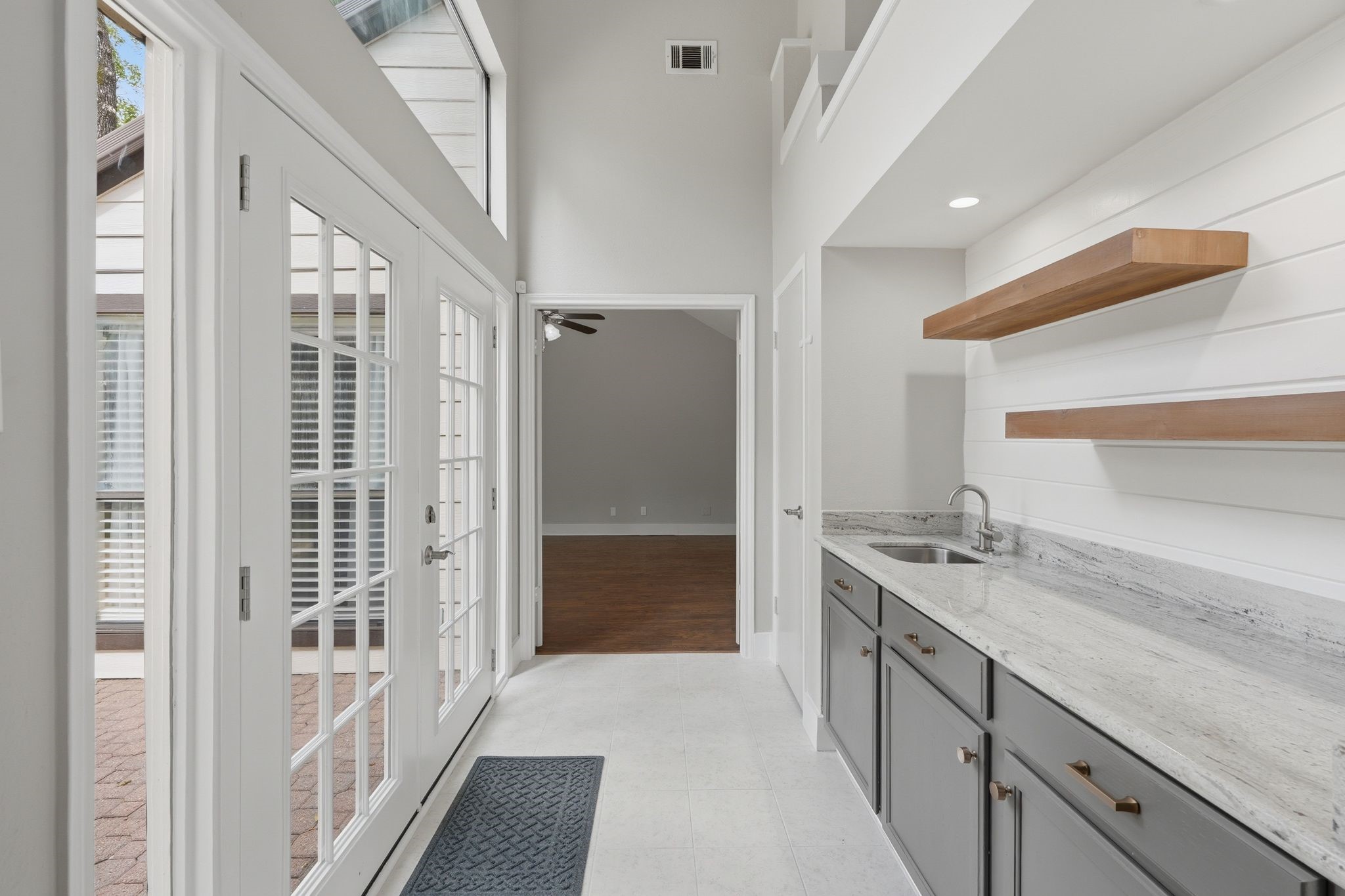 14 Dusky Meadow Place Spring, TX 77381 - Photo 17 of 47 Make a drink at the wet bar area and step outside to the backyard or head straight to the primary bedroom for relaxation.