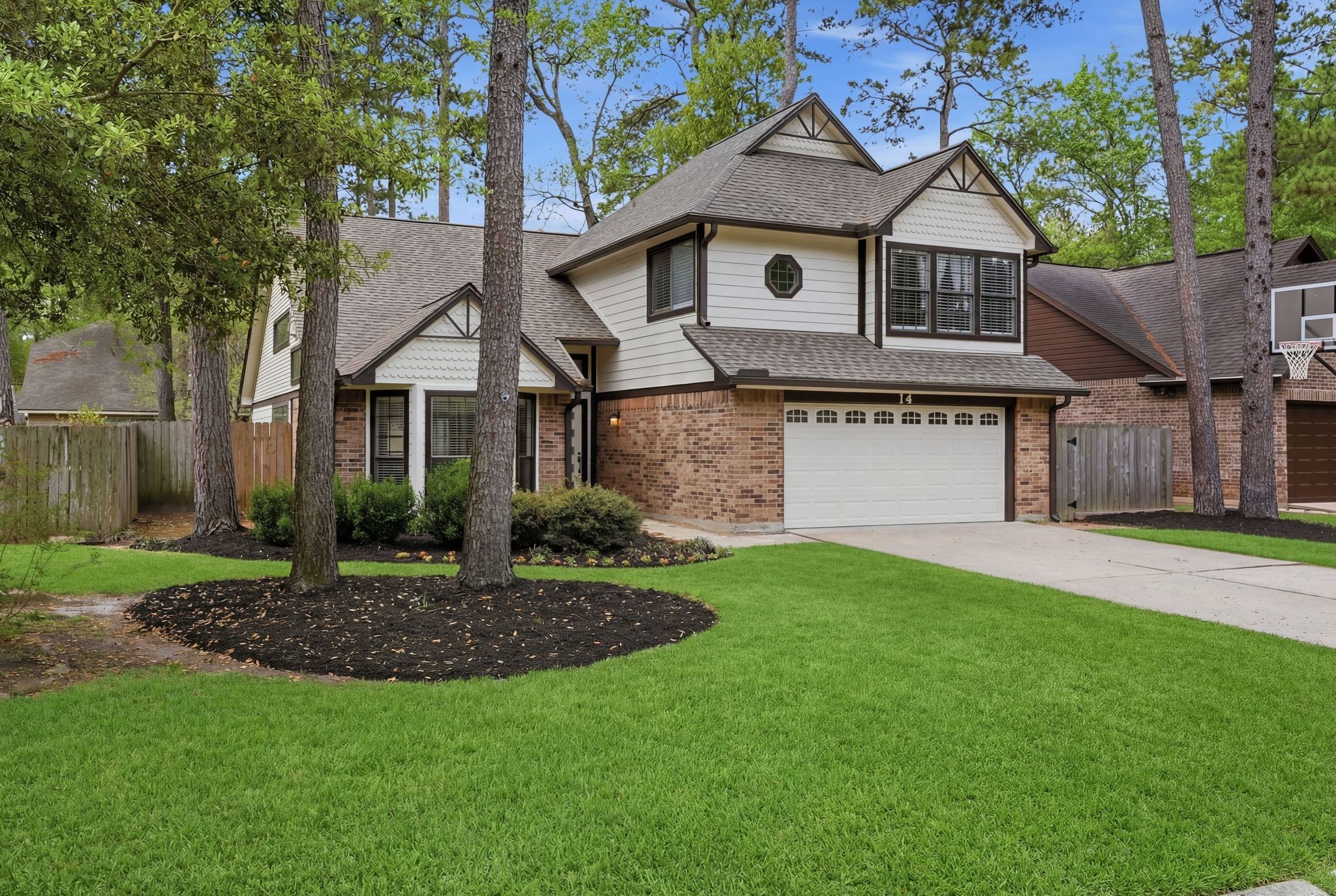 14 Dusky Meadow Place Spring, TX 77381 - Photo 2 of 47 Mature trees and beautifully landscaped yard. It also has a two car garage with a long driveway for multiple vehicles and for playing basketball.