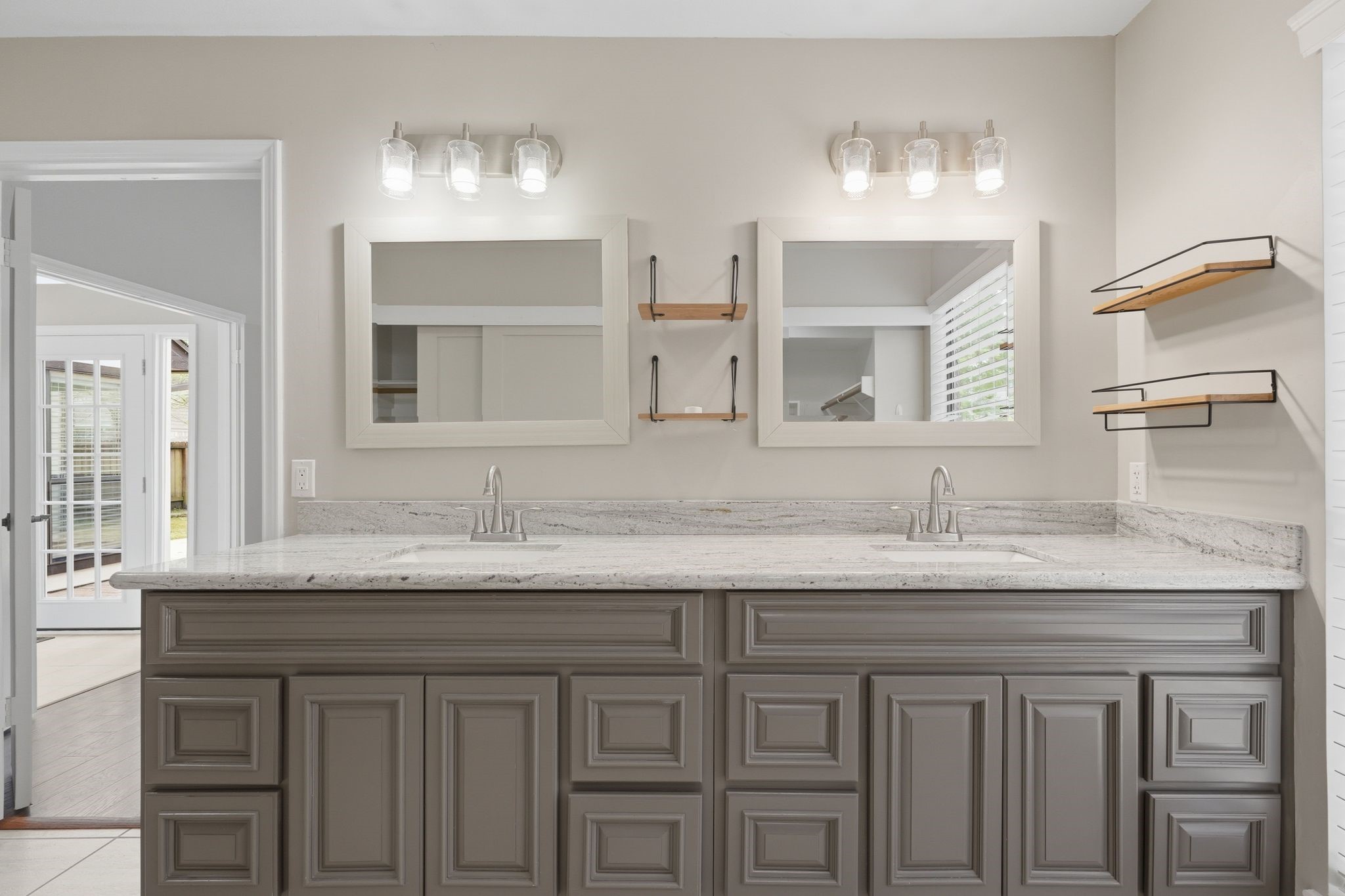 14 Dusky Meadow Place Spring, TX 77381 - Photo 23 of 47 Renovated primary with painted cabinets, granite countertops, framed mirrors and light fixtures!