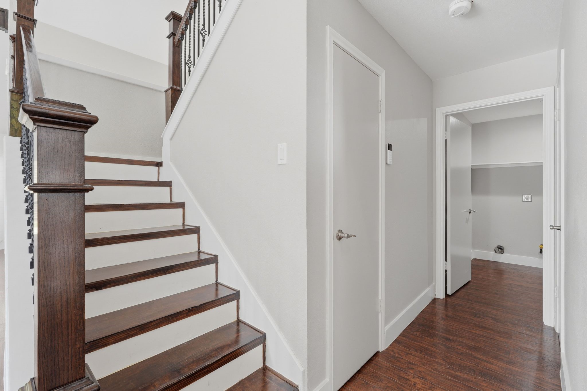 14 Dusky Meadow Place Spring, TX 77381 - Photo 34 of 47 Closer look at the beautiful wood stairs. To the left is a very spacious closet and straight ahead is the laundry room. The half bathroom is the door to the right off the hallway.