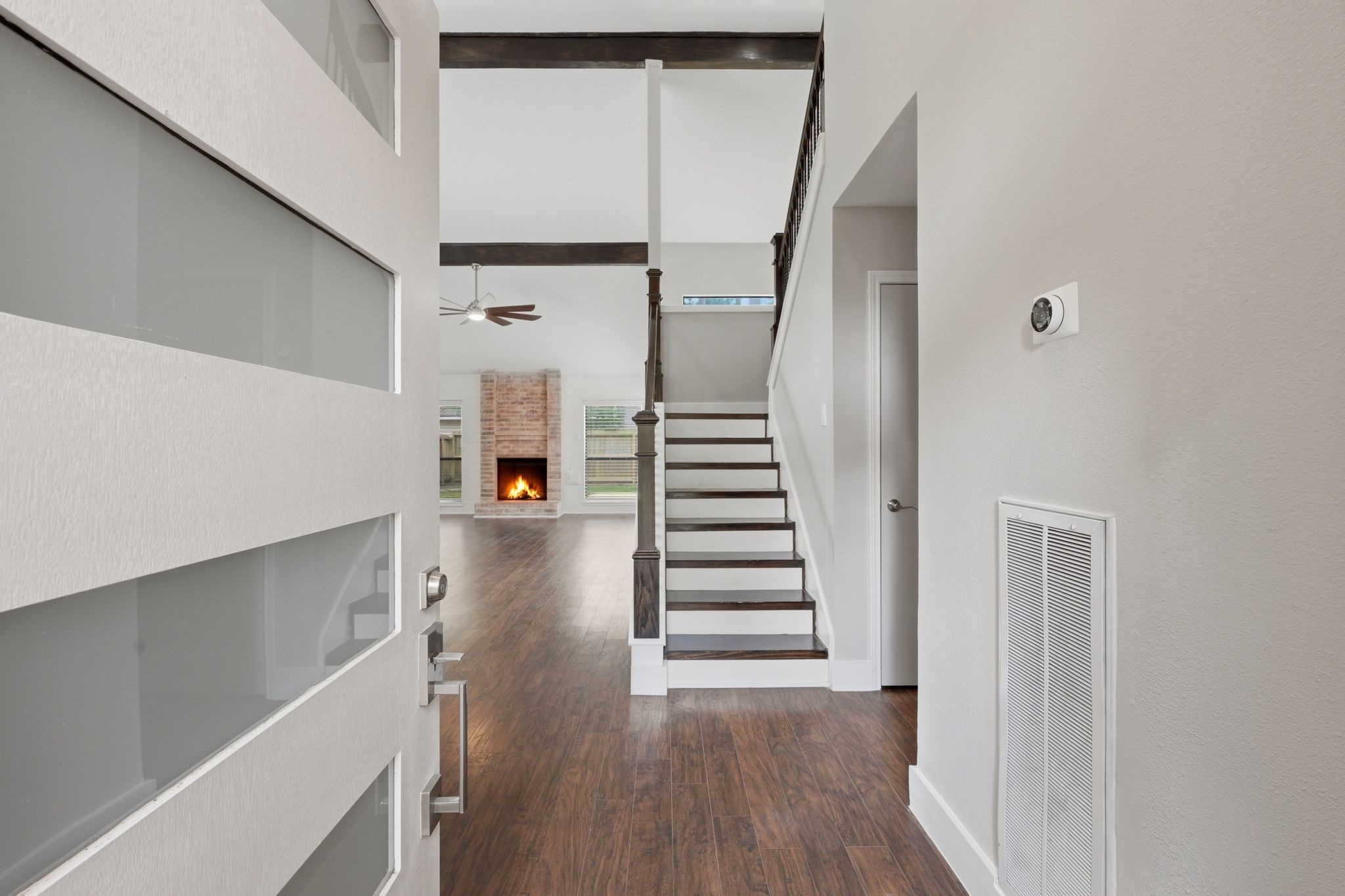 14 Dusky Meadow Place Spring, TX 77381 - Photo 47 of 47 Step inside to an open, airy floor plan with soaring ceilings, rich laminate wood like flooring, and a striking staircase with wood treads and iron balusters.