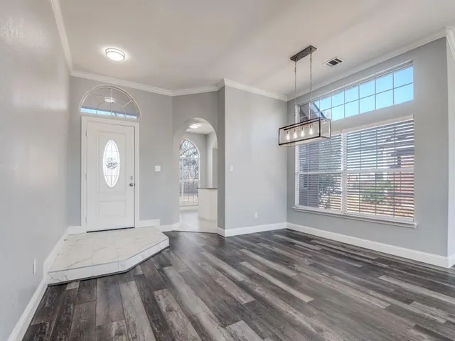 a view of a room with wooden floor and window