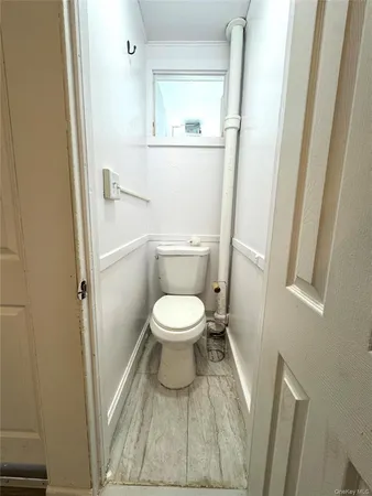a white toilet sitting next to a small sink