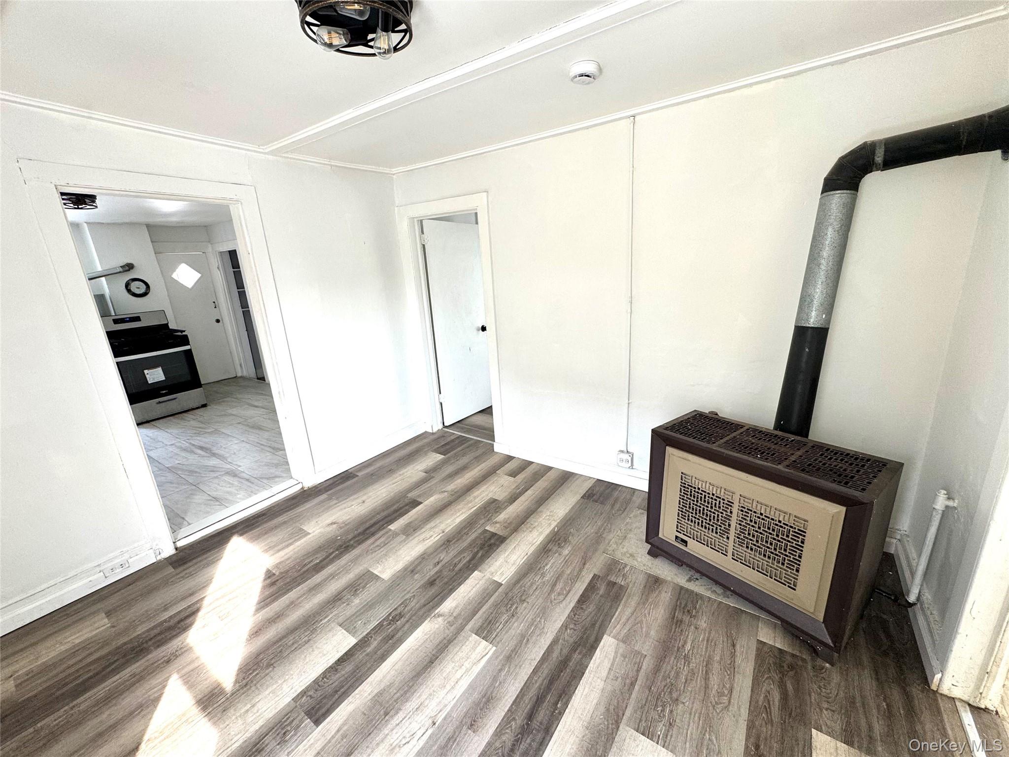 34 Broad Street, Unit 1 Middletown, NY 10940 - Photo 10 of 11 a view of a hallway to a house with wooden floor and furniture