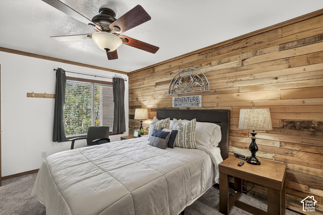 150 Ridgeview Street Brian Head, UT 84719 - Photo 19 of 43 Accent wall featuring horizontal wood paneling, ceiling fan with integrated lighting, window with blinds, and wall-to-wall carpeting