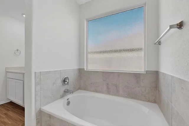 a white bath tub sitting in a bathroom