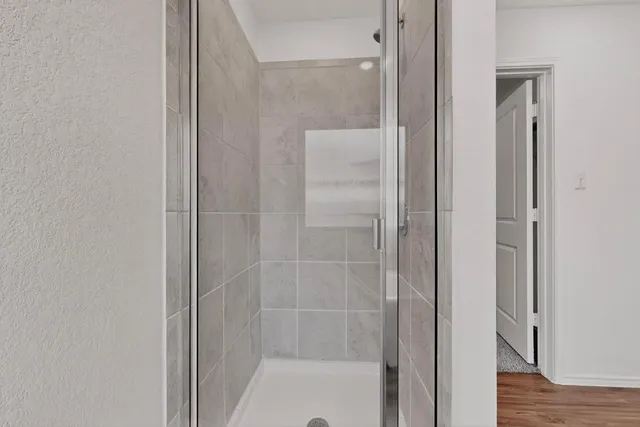 a bathroom with a glass shower door